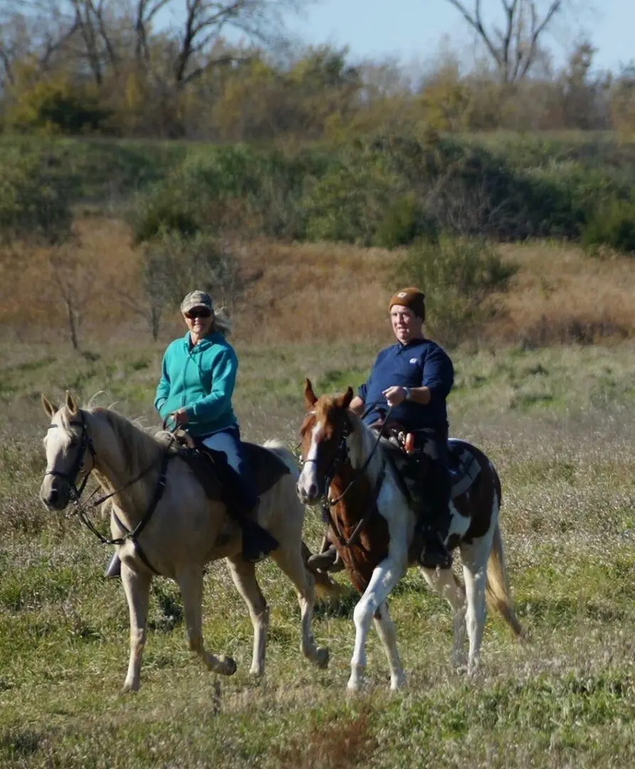 two people riding horses